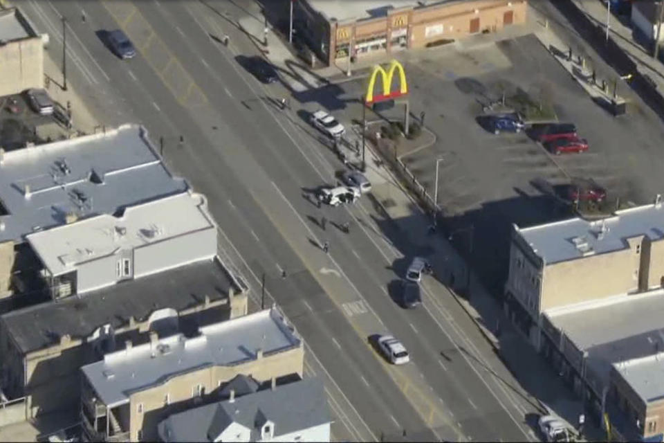 In an image taken from aerial video from WFLD - FOX 32, shows the scene of a shooting during a traffic stop March 21, 2024, in Chicago. A deadly traffic stop where plainclothes Chicago police officers fired nearly 100 shots in under a minute has raised serious questions about the use of force and role of tactical officers in police departments. Family and community members are mourning the shooting death of 26-year-old Dexter Reed and a police oversight agency and Cook County prosecutors are investigating. (WFLD-FOX 32 via AP)