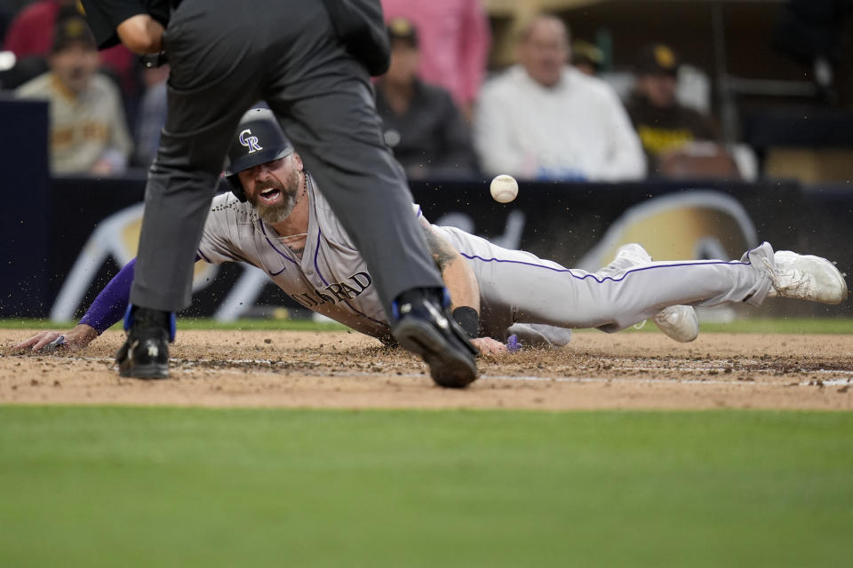 Colorado Rockies' Jake Cave scores from first off a two-RBI double by Elehuris Montero during the fourth inning of a baseball game against the San Diego Padres, Monday, May 13, 2024, in San Diego. (AP Photo/Gregory Bull)