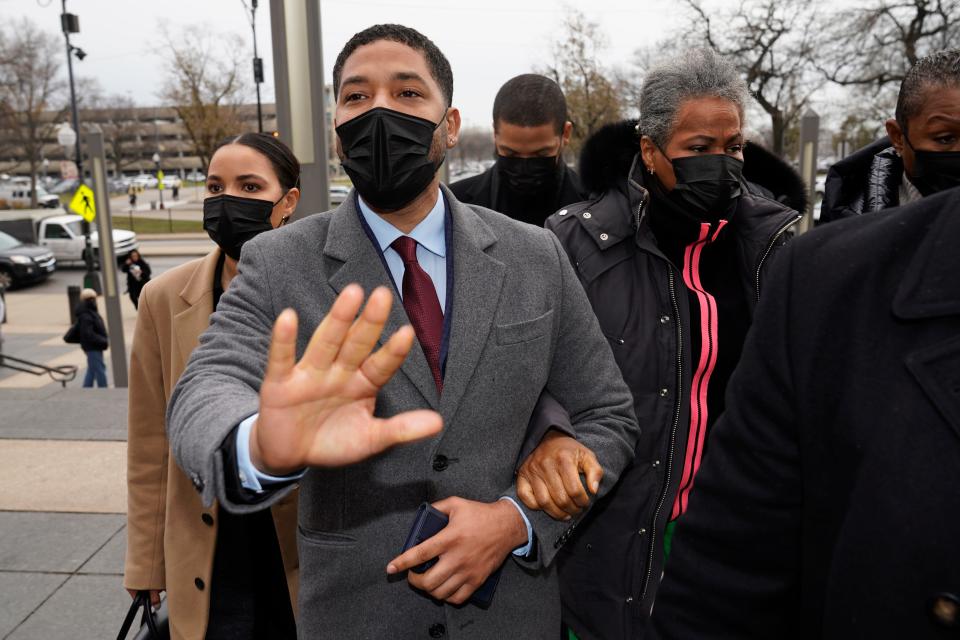 Actor Jussie Smollett asks photographers to move back as he arrives with his mother Janet, right, at the Leighton Criminal Courthouse for day three of his trial in Chicago on Wednesday, Dec. 1, 2021. Smollett is accused of lying to police when he reported he was the victim of a racist, anti-gay attack in downtown Chicago nearly three years ago. (AP Photo/Charles Rex Arbogast)