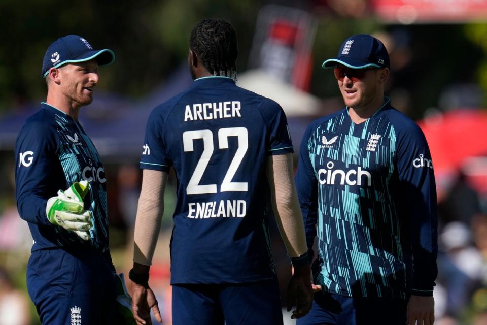England captain Jos Buttler, left, with Jason Roy, right, celebrate with bowler Jofra Archer for taking a wicket (Themba Hadebe/AP) (AP)