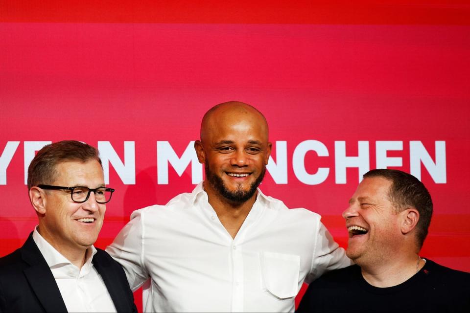 Bayern Munich CEO Jan-Christian Dreesen, left, and sporting director Max Eberl, right, unveil new manager Vincent Kompany  (Getty Images)