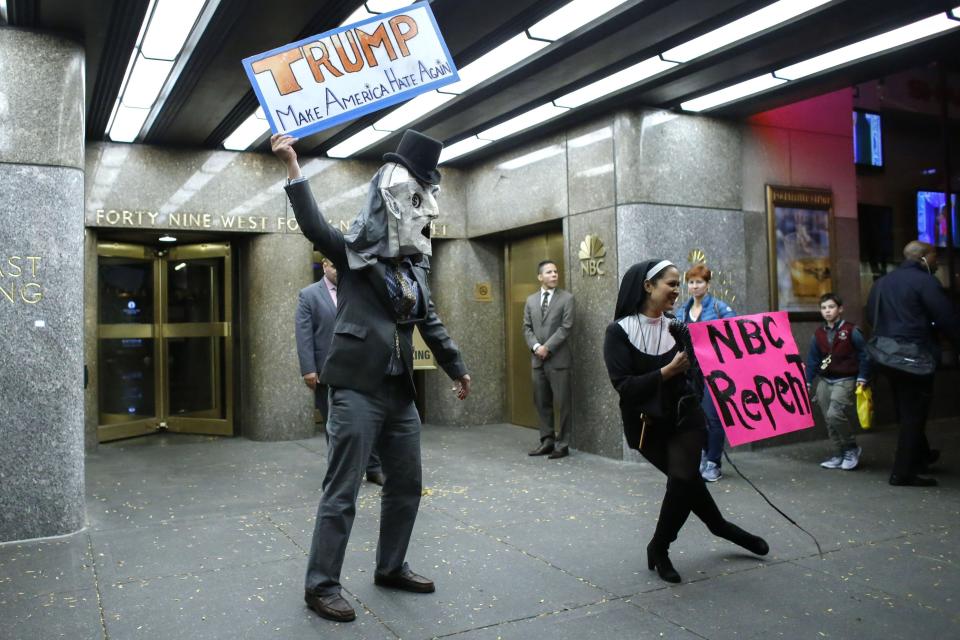 People protest in  front of NBC studios while they are calling for the network to rescind the invitation to Donald Trump to host Saturday Night Live show on November 4, 2015 in New York.