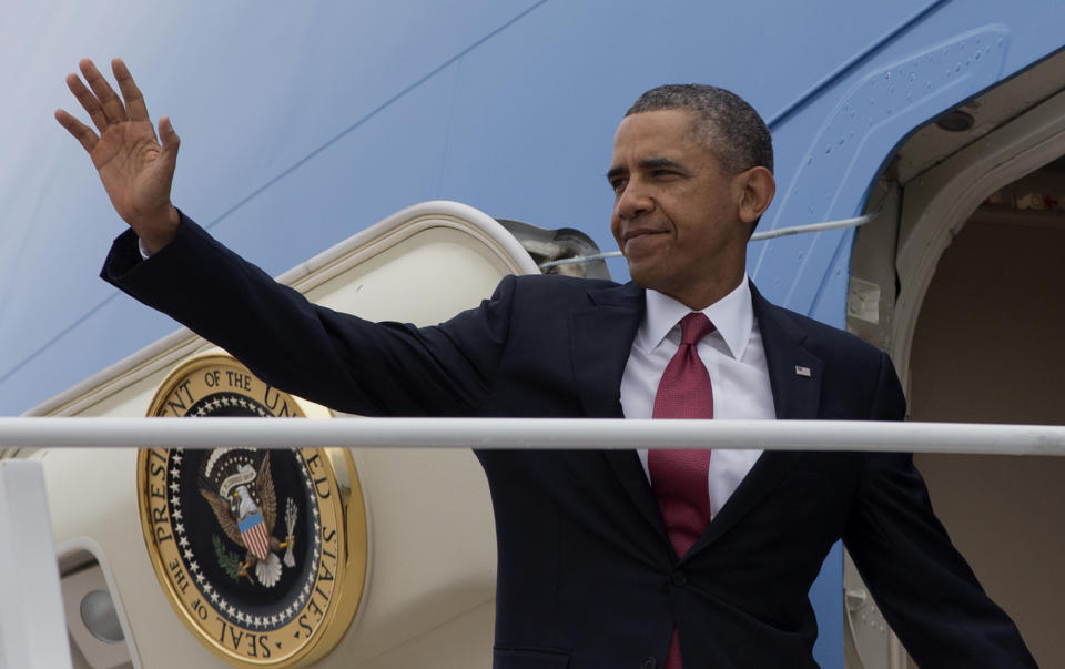 President Barack Obama waves as he boards Air Force One, Wednesday, Jan. 15, 2014, at Andrews Air Force Base, Md. before traveling to North Carolina where he will speak about the economy. (AP Photo/Carolyn Kaster)