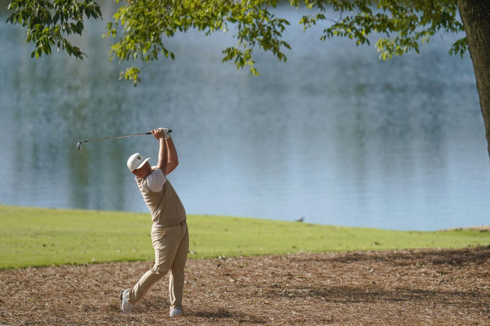 Sungjae Im, of South Korea, hits from the pine straw on the 12th hole during their foursomes match at the Presidents Cup golf tournament at the Quail Hollow Club, Saturday, Sept. 24, 2022, in Charlotte, N.C. (AP Photo/Julio Cortez)