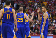 Golden State Warriors guard Stephen Curry, right, congratulates Steve Blake, center, as Klay Thompson looks on during a timeout in the second half in Game 1 of an opening-round NBA basketball playoff series, Saturday, April 19, 2014, in Los Angeles. The Warriors won 109-105. (AP Photo/Mark J. Terrill)