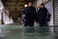 Carabinieri police officers patrol a flooded arcade by St. Mark's square on November 15, 2019 in Venice, two days after the city suffered its highest tide in 50 years. - Flood-hit Venice was bracing for another exceptional high tide on November 15, as Italy declared a state of emergency for the UNESCO city where perilous deluges have caused millions of euros worth of damage. (Photo by FILIPPO MONTEFORTE/AFP via Getty Images)