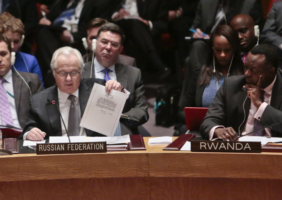 U.N. Russian Ambassador Vitaly Churkin shows a document as he speaks during a meeting of the U.N. Security Council, Monday, March 3, 2014 at U.N. headquarters. (AP Photo/Bebeto Matthews)