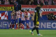 Atletico's Koke, obscured, celebrates his goal with team mates during the Champions League quarterfinal second leg soccer match between Atletico Madrid and FC Barcelona at the Vicente Calderon stadium in Madrid, Spain, Wednesday, April 9, 2014. (AP Photo/Andres Kudacki)