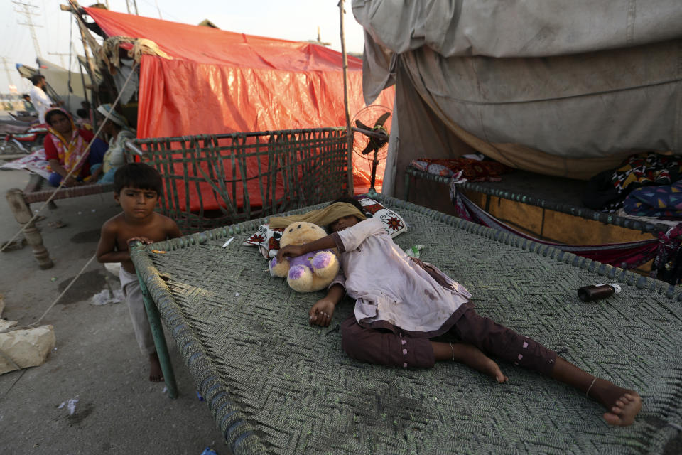 An affected woman sleeps next her tent as she take a refuge after her home was hit by floods in Shikarpur district of Sindh Province, of Pakistan, Thursday, Sep. 1, 2022. Pakistani health officials on Thursday reported an outbreak of waterborne diseases in areas hit by recent record-breaking flooding, as authorities stepped up efforts to ensure the provision of clean drinking water to hundreds of thousands of people who lost their homes in the disaster. (AP Photo/Fareed Khan)