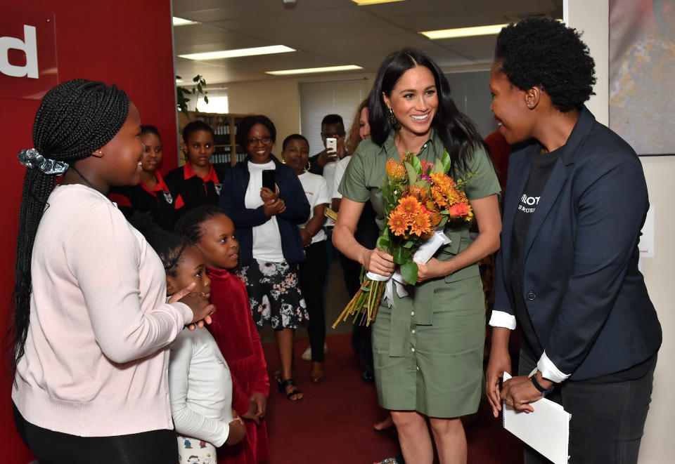 The Duchess of Sussex was presented flowers by Luyanda, age 8, during her visit to ActionAid. (Photo: Pool via Getty Images)