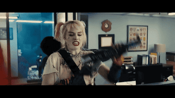 margot robbie as harley quinn flips an opponent over her shoulder in "birds of prey"