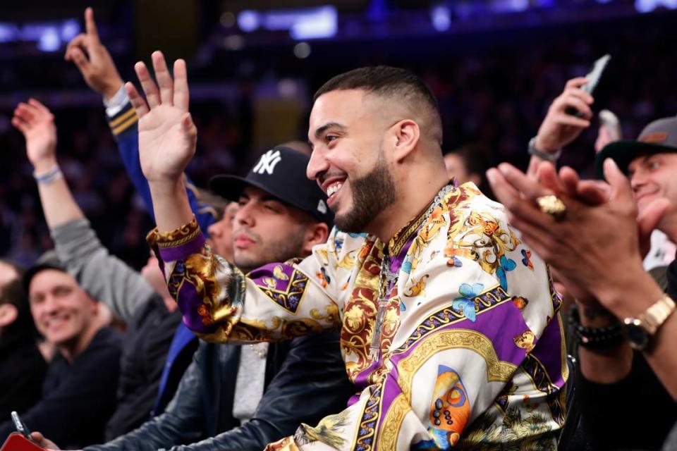 Three-time Grammy nominated rapper French Montana waves to the crowd during the first half of an NBA basketball game between the New York Knicks and the Detroit Pistons in New York, Sunday, March 8, 2020. (AP Photo/Kathy Willens)
