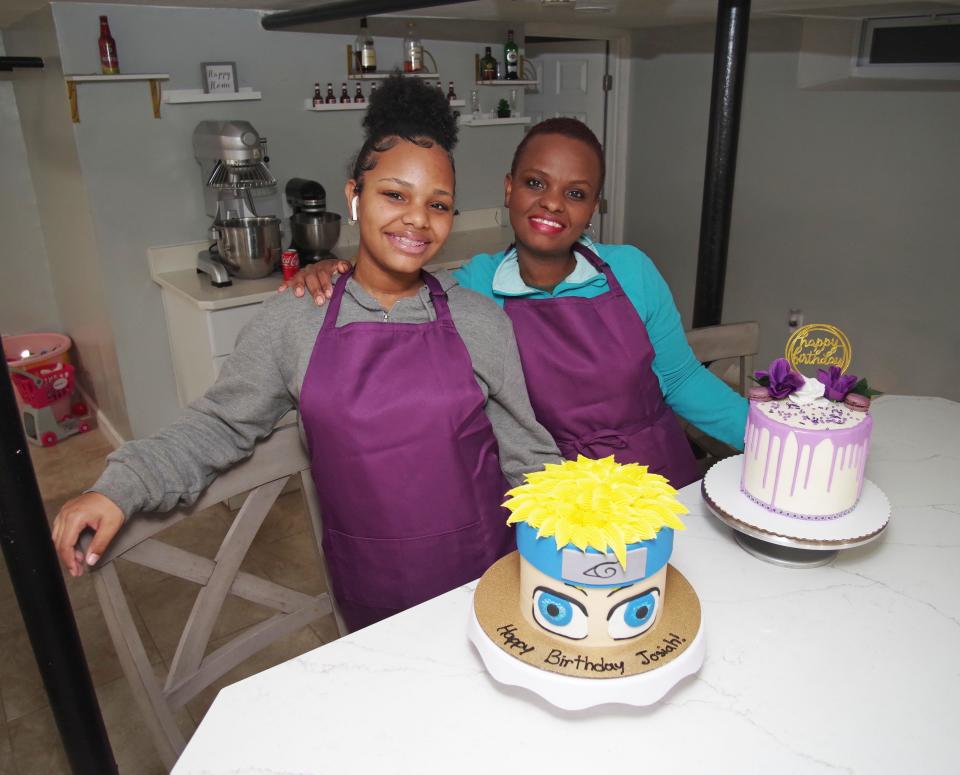 Fourteen-year-old Serina Ribeiro of Brockton, left,  stands with her mother Lenilda Ribeiro on Thursday, March 3, 2022, after completing two high crafted cakes with great attention to design and detail. Serina would someday like to open a chain business of bakeries specializing in custom cakes.