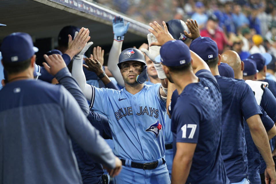 Toronto Blue Jays' Whit Merrifield celebrates his three-run home run against the Detroit Tigers in the ninth inning of a baseball game, Friday, July 7, 2023, in Detroit. (AP Photo/Paul Sancya)