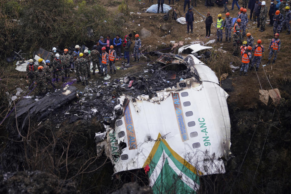 Rescuers scour the crash site in the wreckage of a passenger plane in Pokhara, Nepal, Monday, Jan.16, 2023. The Yeti Airlines flight from Kathmandu that plummeted into a gorge Sunday killed at least 70 passengers out of the 72 on board. (AP Photo/Yunish Gurung)