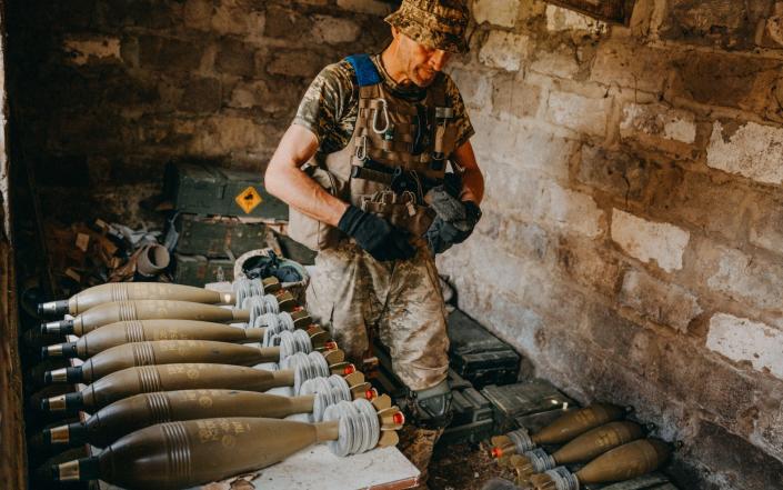 Andrii, Ukrainian soldier from the 35th Brigade, inspects 120mm mortar shells on the firing position near one of newly captured villages in Makarivka