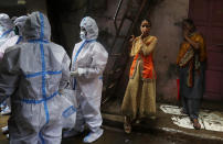 Health workers screen residents for COVID-19 symptoms at Dharavi, one of Asia's biggest slums, in Mumbai, India, Monday, Aug. 3, 2020. India is the third hardest-hit country by the pandemic in the world after the United States and Brazil. (AP Photo/Rafiq Maqbool)