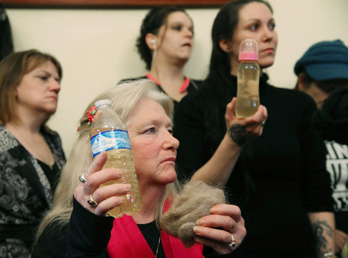 <p>FEB. 3, 2016 — Flint residents Gladyes Williamson (C) holds a bottle full of contaminated water, and a clump of her hair, alongside Jessica Owens (R), holding a baby bottle full of contaminated water, during a news conference after attending a House Oversight and Government Reform Committee hearing on the Flint, Michigan water crisis on Capitol Hill in Washington, DC. Williamson, and Owens traveled to Washington by bus with other flint familes to attend the House hearing on the crisis, and demand that Michigan Gov. Rick Snyder be brought before Congress to testify under oath. (Mark Wilson/Getty Images) </p>