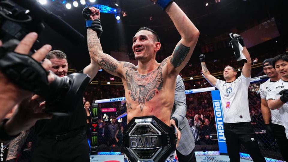 Max Holloway celebrates beating Justin Gaethje