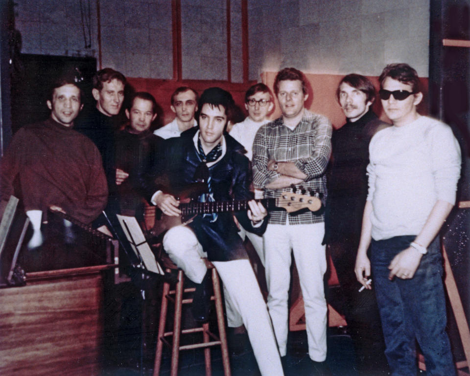 In this Jan. 22, 1969 photo provided by Elvis Presley Enterprises, Inc., Elvis Presley, center, poses for a photo at American Sound Studio with The Memphis Boys, an acclaimed studio band that worked with Elvis on two albums in 1969, in Memphis, Tenn. Bobby Wood, left, is playing in a concert in Memphis on Aug. 16, 2012 the 35th anniversary of Elvis’ death in Memphis. Thousands of Elvis fans are expected to visit Graceland during Elvis Week, an annual celebration of the life of the late rock and roll icon. (AP Photo/Elvis Presley Enterprises, Inc., Robert Dye)