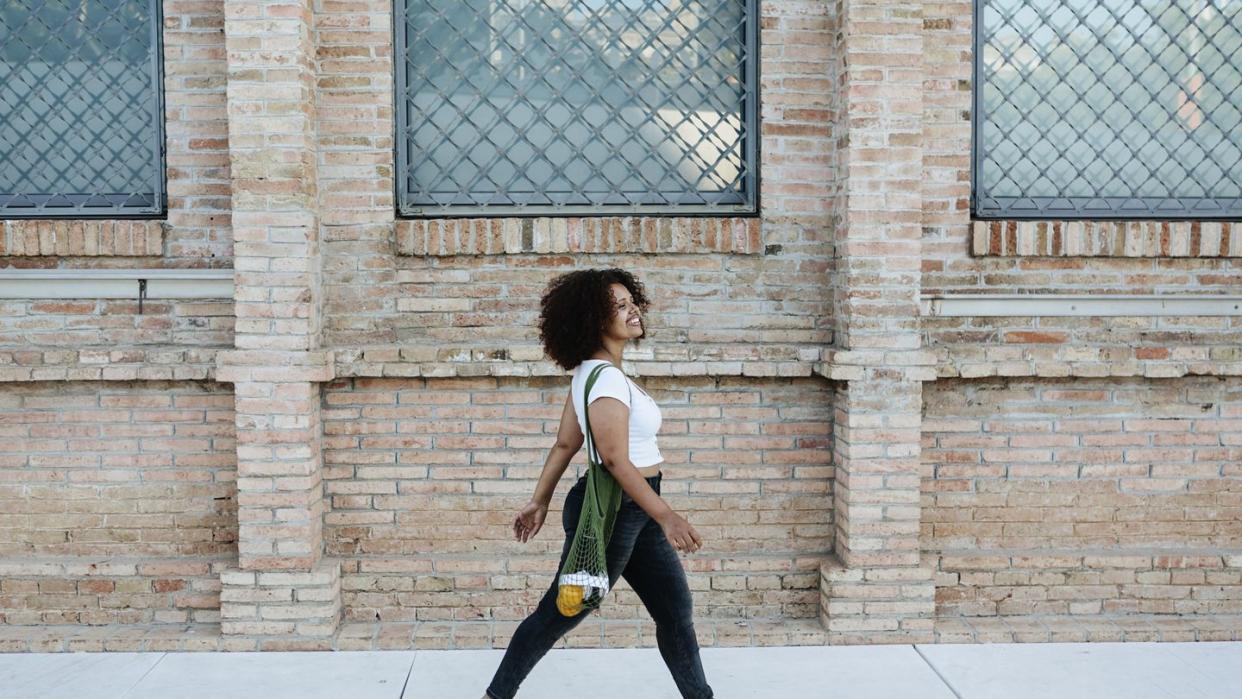 happy woman walking in the street