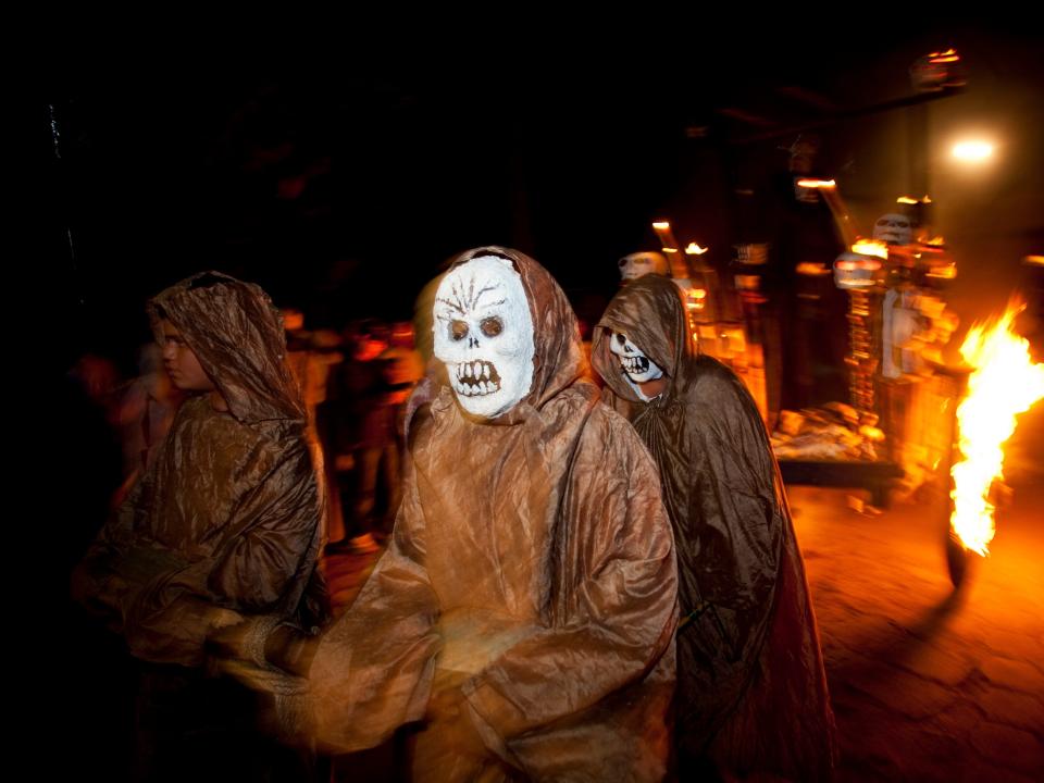 People parade in commemoration of the Day of the Dead in Tonacatepeque, outskirts of San Salvador, Sunday, Nov. 1, 2009.