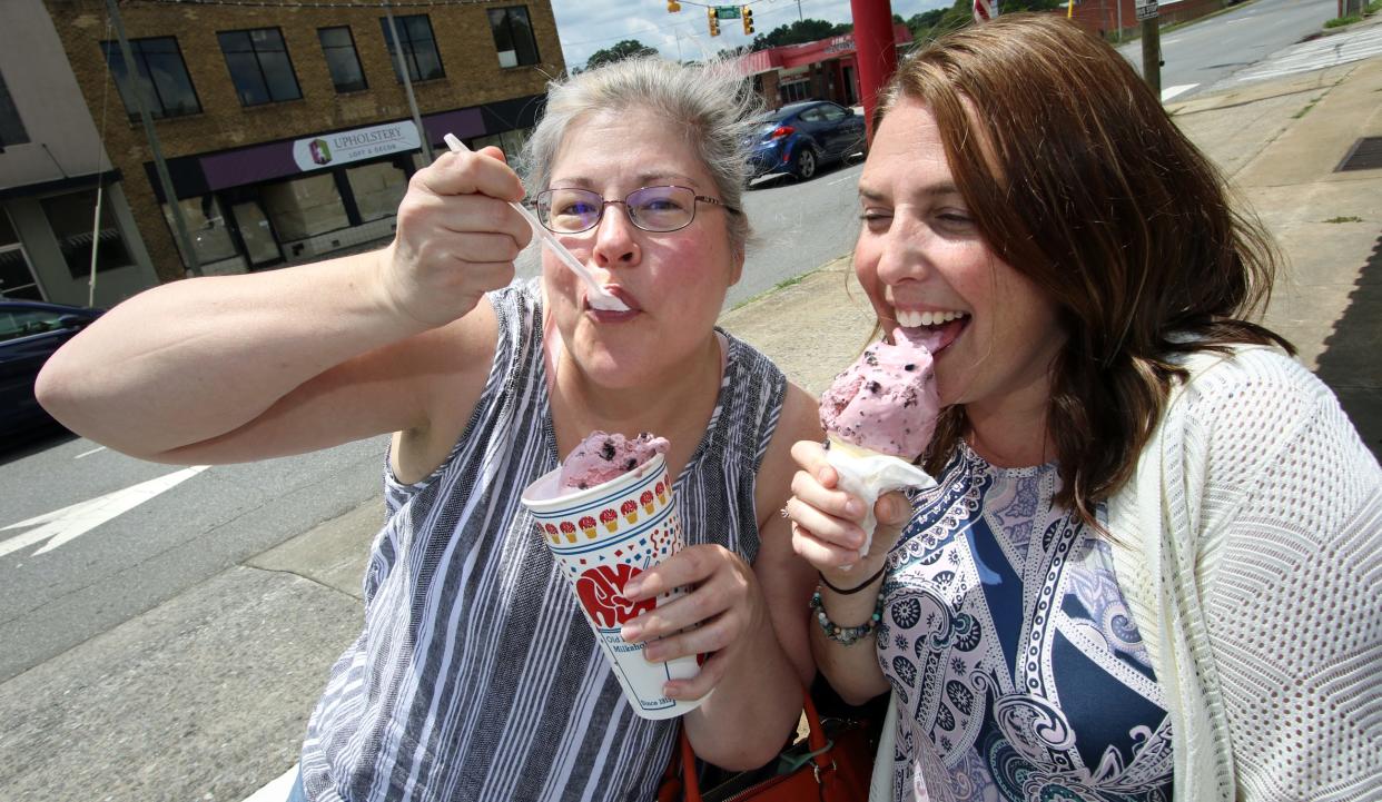 Christine Pasour takes a bite out of her black cherry milkshake as her friend, Ali Pezza, takes a lick of her black cherry cone during their lunch break at Tony’s Ice Cream Tuesday afternoon, July 19, 2022.