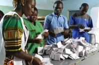 Scrutineers are at work during the counting of Burkina Faso's presidential election votes at a polling station in Ouagadougou on November 29, 2015