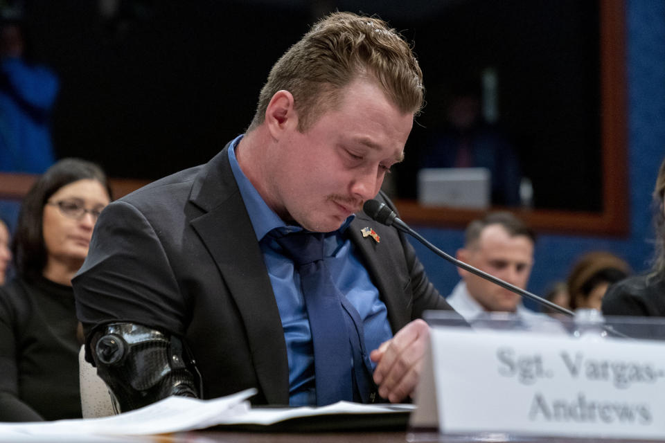 Former Marine Sgt. Tyler Vargas-Andrews, who was gravely injured, losing an arm and a leg in a suicide attack at Hamid Karzai International Airport in Kabul, becomes emotional as he recounts his story during a House Committee on Foreign Affairs hearing on the United States evacuation from Afghanistan on Capitol Hill in Washington, Wednesday, March 8, 2023. (AP Photo/Andrew Harnik)