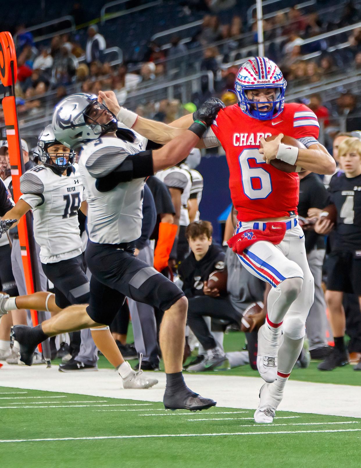 Westlake quarterback Cade Klubnik, right, stiff-arms Denton Guyer safety Jaden Powell during Westlake's win in the Class 6A Division II championship game in December. Klubnik earned the Class 6A’s offensive player of the year award from the Texas Sports Writers Association after throwing for 3,251 yards, 43 touchdowns and only three interceptions.