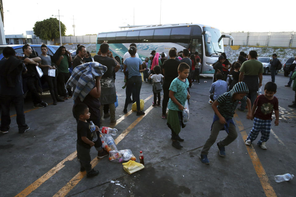 In this July 16, 2019 photo, migrants wait outside at an immigration center on the International Bridge 1, to be bused from Nuevo Laredo to Monterrey Mexico. The migrants went willingly knowing the dangers that lurk in Tamaulipas, where organized crime groups have been known to extort, kidnap and kill people like them. (AP Photo/Marco Ugarte)