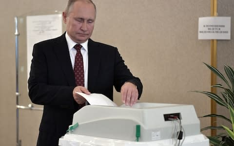 Mr Putin casts his ballot on Sunday - Credit: Alexey Nikolsky/Kremlin pool/EPA-EFE/REX