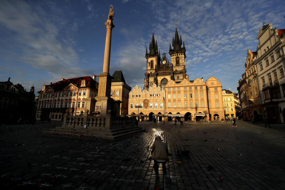 A man pays respect to victims of the COVID-19 pandemic at a spontaneous memorial place set at the Old Town Square in Prague, Czech Republic, Monday, March 29, 2021. The coronavirus pandemic is unleashing enormous suffering as infection rates rise across central Europe even as the Czech Republic and Slovakia, recently among the worst-hit areas in the world, are finally seeing some improvements following tight lockdowns. (AP Photo/Petr David Josek)