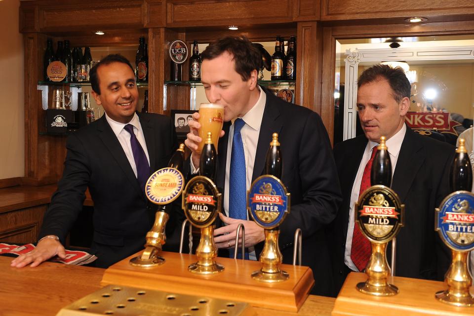 Chancellor George Osborne with a pint of Sunbeam ale alongside Conservative MP for Wolverhampton south west Paul Uppal (left) and chief executive Ralph Findlay (right) during a visit to Marston's Brewery in Wolverhampton.