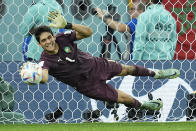 Morocco's goalkeeper Yassine Bounou stops a penalty shot by Spain's Sergio Busquets during a penalty shootout of the World Cup round of 16 soccer match between Morocco and Spain, at the Education City Stadium in Al Rayyan, Qatar, Tuesday, Dec. 6, 2022. (AP Photo/Ebrahim Noroozi)