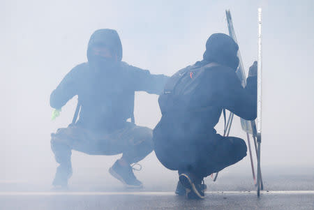 Protesters react to tear gas at a demonstration during the Act XXIV (the 24th consecutive national protest on Saturday) of the yellow vests movement in Strasbourg, France, April 27, 2019. REUTERS/Vincent Kessler