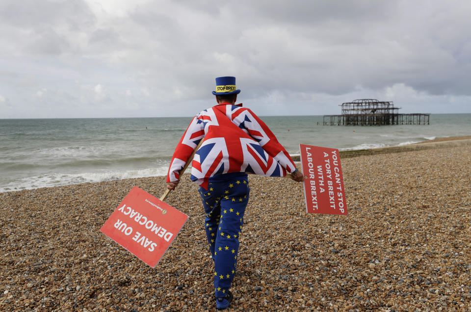 Anti Brexit campaigner Steve Bray walks on the beach to pose for a photograph during the Labour Party Conference at the Brighton Centre in Brighton, England, Monday, Sept. 23, 2019. (AP Photo/Kirsty Wigglesworth)