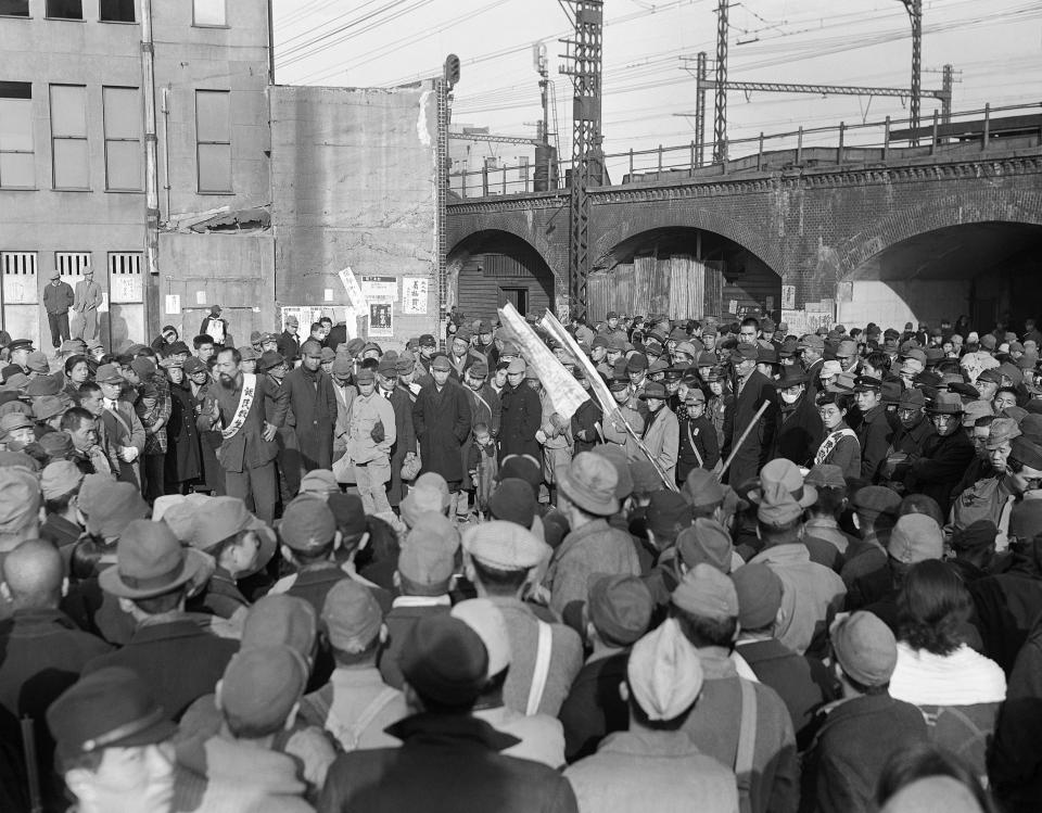 FILE - In this Dec. 16, 1945, file photo, a crowd gathers at Shimbashi railroad station in Tokyo for a hunger demonstration by residents of the city. The bombs stopped falling 75 years ago, but it is entirely possible - crucial even, some argue - to view the region’s world-beating economies, its massive cultural and political reach and its bitter trade, territory and history disputes all through a single prism: Japan’s aggression in the Pacific during World War II. (AP Photo/JW, File)