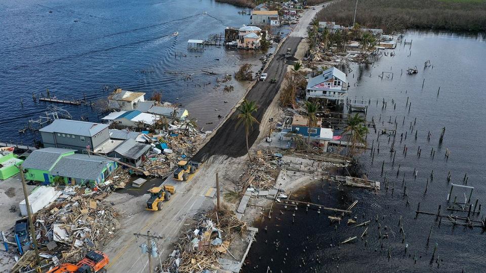 In this aerial view, a FDOT crew works on repairing the road that goes to Pine Island on October 4, 2022, in Matlacha, Florida. The original road was made unpassable after Hurricane Ian passed through the area and washed out sections of the road.