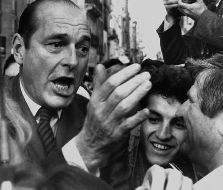 FILE PHOTO: French Prime Minister Jacques Chirac jokes with supporters during his visit in Bordeaux