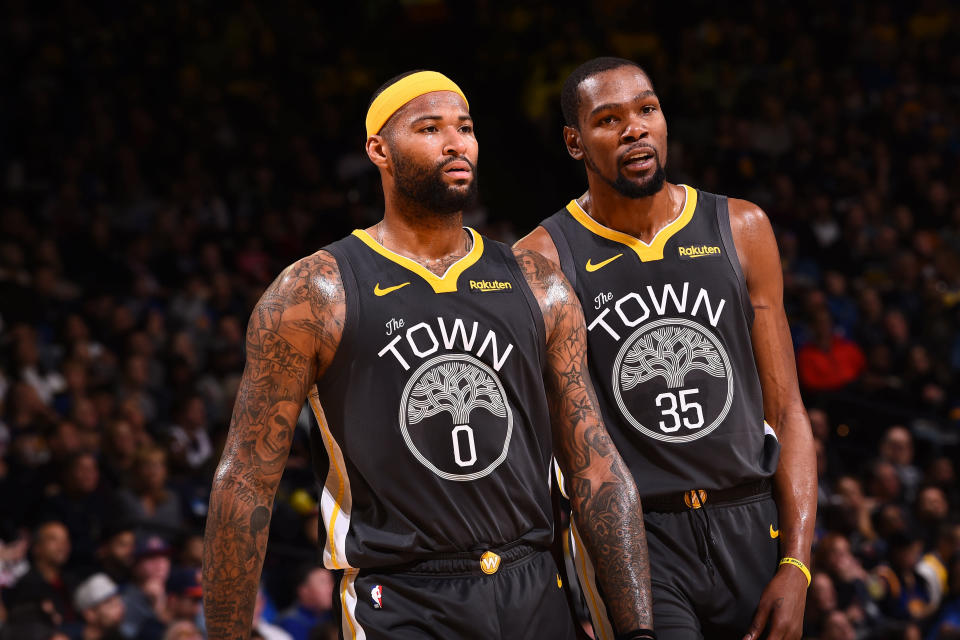 OAKLAND, CA - FEBRUARY 10: Demarcus Cousins #0 and Kevin Durant #35 of the Golden State Warriors look on during the game against the Miami Heat  on February 10 at ORACLE Arena in Oakland, California. NOTE TO USER: User expressly acknowledges and agrees that, by downloading and or using this photograph, user is consenting to the terms and conditions of Getty Images License Agreement. Mandatory Copyright Notice: Copyright 2019 NBAE (Photo by Noah Graham/NBAE via Getty Images)