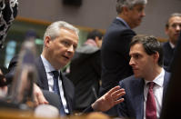 French Finance Minister Bruno Le Maire, left, speaks with Dutch Finance Minister Wopke Hoekstra during a meeting of EU finance ministers at the Europa building in Brussels, Tuesday, Feb. 18, 2020. EU finance ministers meet Tuesday to discuss tax havens. (AP Photo/Virginia Mayo)