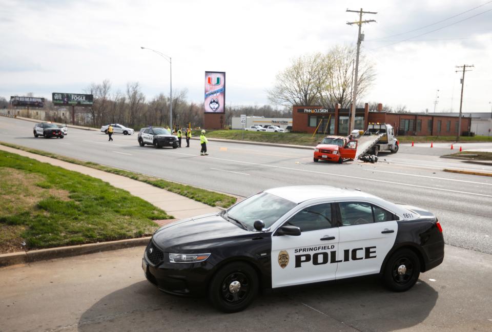 A pickup truck is towed away after being involved in a crash with a motorcycle on North Glenstone Avenue between Chestnut Expressway and St. Louis Street on Thursday, March 30, 2023.