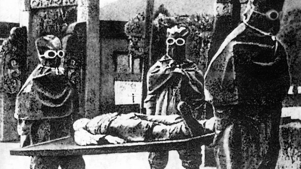  Japanese Unit 731 staff carrying a body from one of the unit's facilities. 