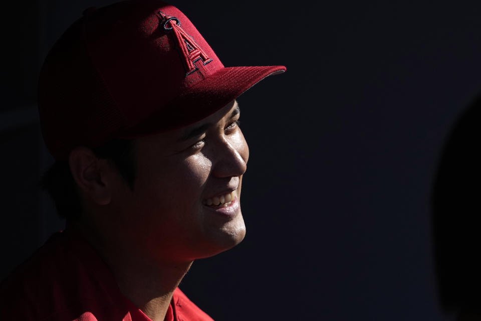 FILE - Los Angeles Angels' Shohei Ohtani talks to people in the dugout prior to a baseball game against the Los Angeles Dodgers Friday, July 7, 2023, in Los Angeles. Shohei Ohtani has been named The Associated Press' Male Athlete of the Year for the second time in three years. (AP Photo/Mark J. Terrill, File)