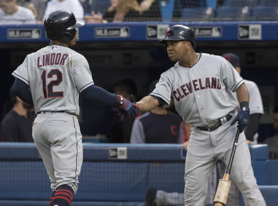 Cleveland Indians' Francisco Lindor celebrates with Jose Ramirez after he hit a leadoff home run against the Toronto Blue Jays during the first inning of a baseball game Thursday, Sept. 6, 2018, in Toronto. (Fred Thornhill/The Canadian Press via AP)