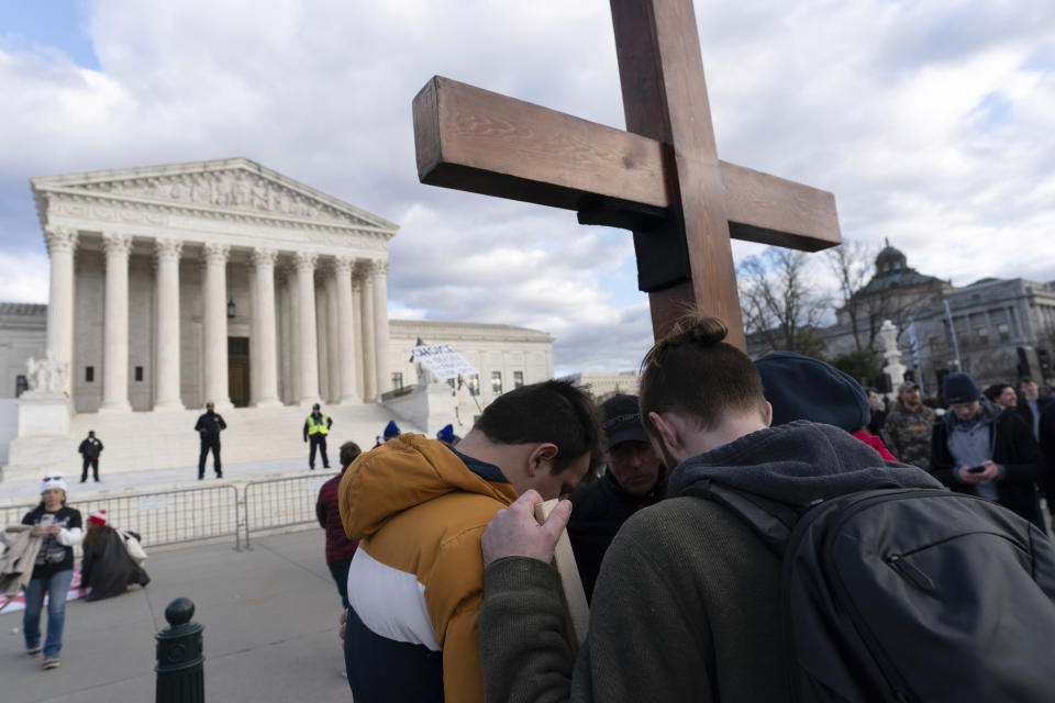 FILE - Anti-abortion activists have a pray as they rally outside of the U.S. Supreme Court during the March for Life in Washington, Friday, Jan. 20, 2023. One year ago, the U.S. Supreme Court rescinded a five-decade-old right to abortion, prompting a seismic shift in debates about politics, values, freedom and fairness. (AP Photo/Jose Luis Magana, File)