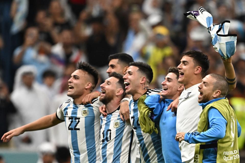 Argentina's forward #10 Lionel Messi (2-L) and teammates celebrate with the crowd after qualifying to the next round after defeating Netherlands in the penalty shoot-out of the Qatar 2022 World Cup quarter-final football match between Netherlands and Argentina at Lusail Stadium, north of Doha, on December 9, 2022. (Photo by MANAN VATSYAYANA / AFP) (Photo by MANAN VATSYAYANA/AFP via Getty Images)