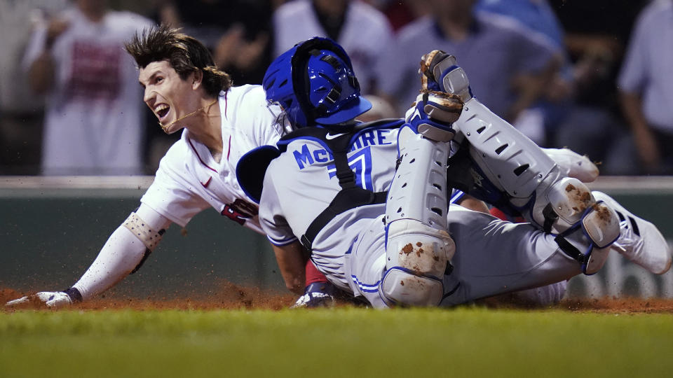 Boston Red Sox's Jarren Duran dives home to score, while advancing on an error after hitting an RBI triple, beating the tag by Toronto Blue Jays catcher Reese McGuire (7) during the fourth inning of the second baseball game of a doubleheader at Fenway Park, Wednesday, July 28, 2021, in Boston. (AP Photo/Charles Krupa)