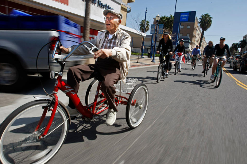Octavio Orduno, 103 leads the pack of local cyclists through the streets of downtown Long Beach.